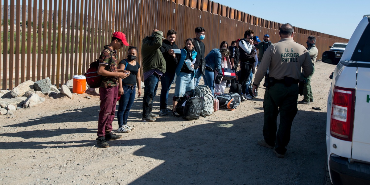 Migrants,From,Columbia,Wait,To,Be,Processed,After,Turning,Themselves